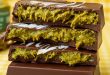 Close-up of sliced Dubai chocolate bar showing creamy pistachio filling inside.