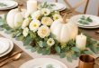 Elegant Thanksgiving centerpiece with white pumpkins cream florals and eucalyptus on a white table DIY Thanksgiving Table Centerpiece Ideas