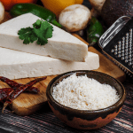 A single shot focusing on grated cotija cheese, illustrating what is cotija cheese in detail, while also hinting at a cotija cheese substitute for those curious about cojita cheese alternatives.