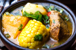 A close-up shot of a Caldo de Res recipe bowl featuring tender beef, corn, and vegetables, topped with fresh cilantro, highlighting the soup’s warm and comforting texture