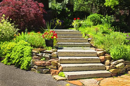 Natural stone landscaping in home garden with stairs