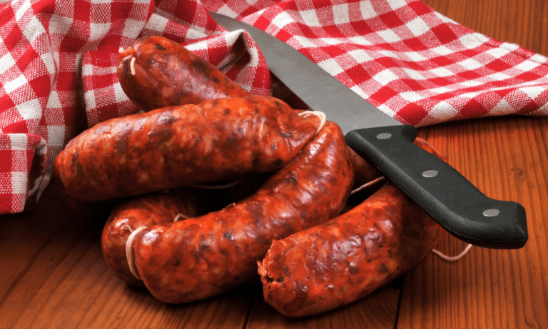 Fresh raw Spanish chorizo sausages on a rustic wooden table, highlighting the best ingredients and tips on how to cook chorizo to perfection.